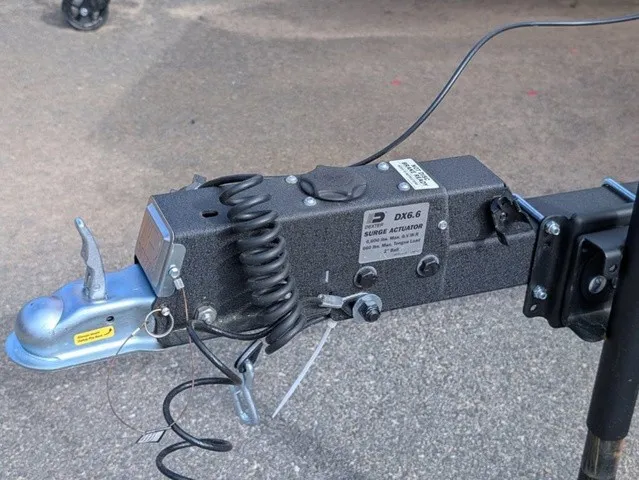 Slide: The Image of Close-up of a trailer hitch with cables and a lever. - 3