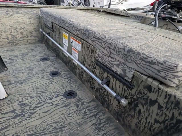 Slide: The Image of The image shows the interior of a Tracker Grizzly 1860 CC with a camouflage design. - 26