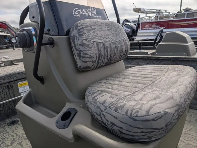 Slide: The Image of A 2026 Tracker Grizzly 1860 CC with a padded seat and steering console. - 9