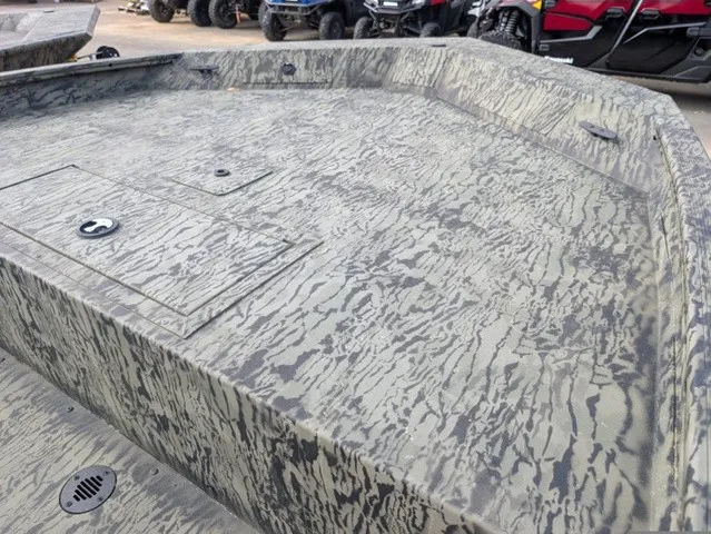 Slide: The Image of The image shows the deck of a Tracker Grizzly 1860 CC boat with a camouflage pattern. - 8