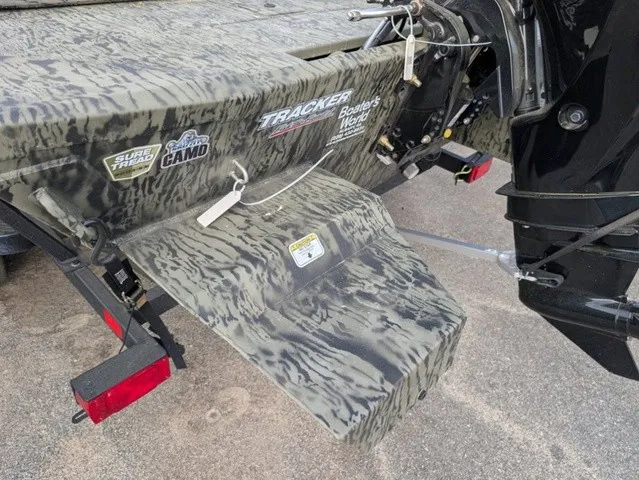 Slide: The Image of The image shows the rear of a Tracker Grizzly 1860 CC boat with a camouflage design. - 20