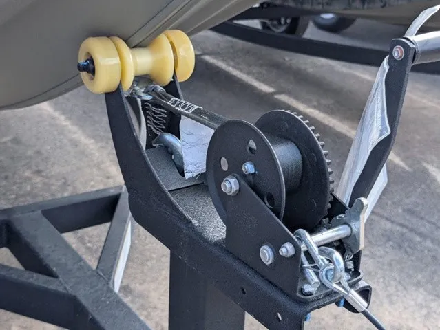 Slide: The Image of Close-up of a boat trailer winch with yellow rollers on a trailer. - 4