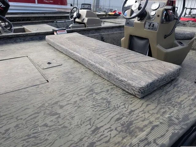 Slide: The Image of The image shows the deck of a Tracker Grizzly 1860 CC boat with a cushioned seat. - 13
