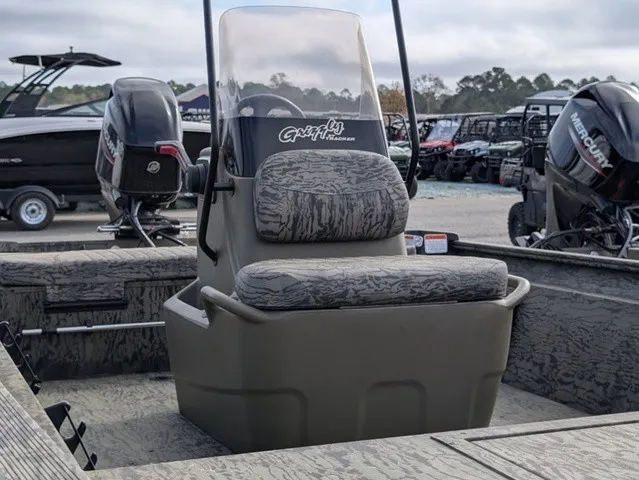 Slide: The Image of The image shows a Tracker Grizzly 1860 CC boat with a central console and cushioned seat. - 6
