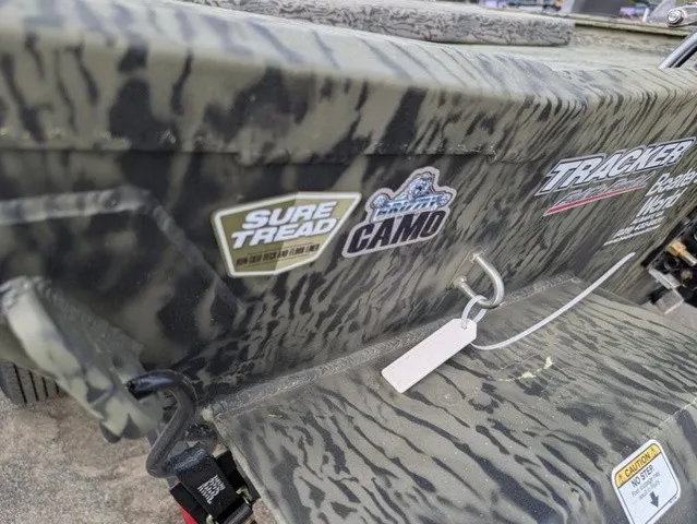 Slide: The Image of Close-up of a Tracker Grizzly 1860 CC with camouflage pattern and decals. - 21