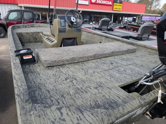 Slide: The Image of The image shows a Tracker Grizzly 1860 CC boat with a camo design and a central console. - 19