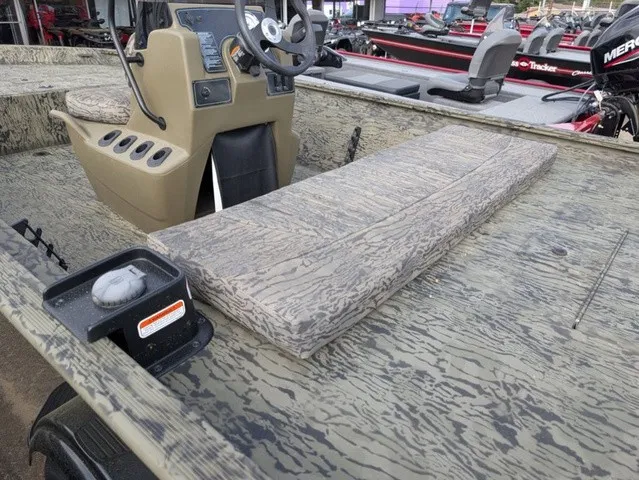 Slide: The Image of The image shows a Tracker Grizzly 1860 CC boat with a rugged, camo design and a console. - 23