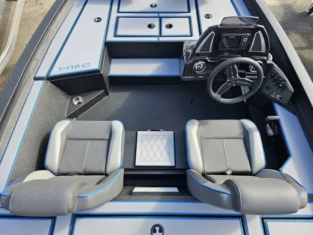 Slide: The Image of The image shows the cockpit of a 2026 Xpress H18C Crappie boat with two cushioned seats and a modern helm. - 29