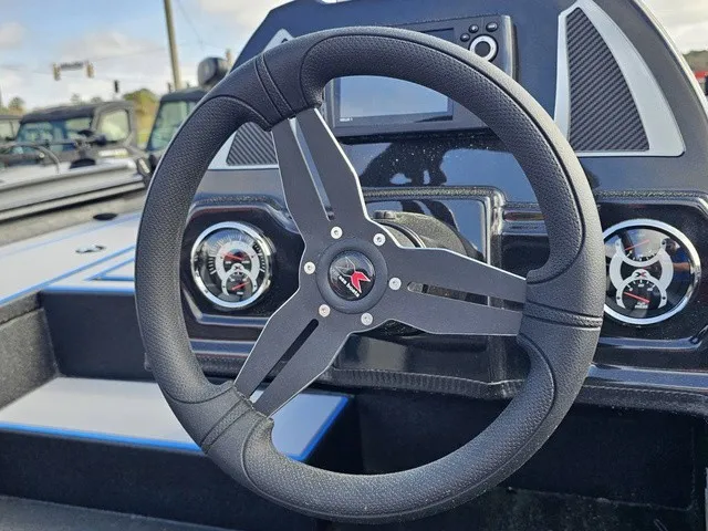 Slide: The Image of The image shows the steering wheel of an Xpress H18C Crappie boat with gauges and a screen. - 24