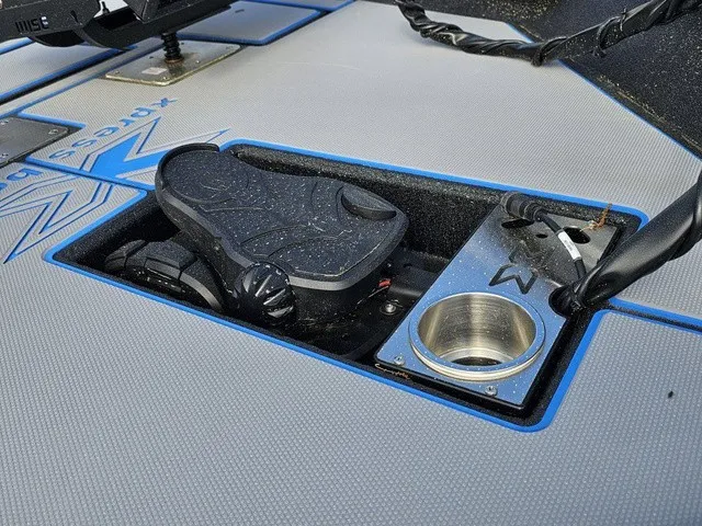 Slide: The Image of The image shows the cockpit of an Xpress H18C Crappie boat with pedal control and cup holder. - 17