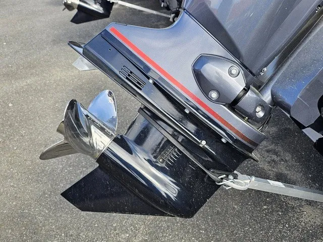 Slide: The Image of Close-up of a shiny outboard motor with a propeller, mounted on a boat. - 11