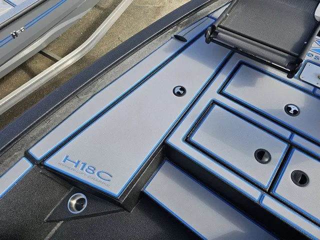 Slide: The Image of The image shows the deck of an Xpress H18C Crappie boat with blue accents. - 31