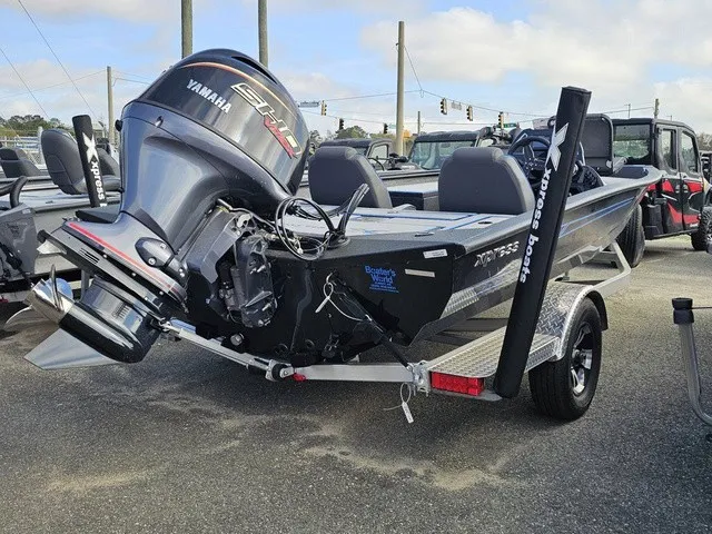 Slide: The Image of A 2026 Xpress H18C Crappie boat on a trailer, equipped with a Yamaha engine. - 8