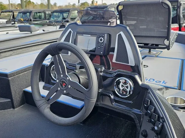 Slide: The Image of The image shows the cockpit of a 2026 Xpress H18C Crappie boat with a modern steering wheel and screen. - 23