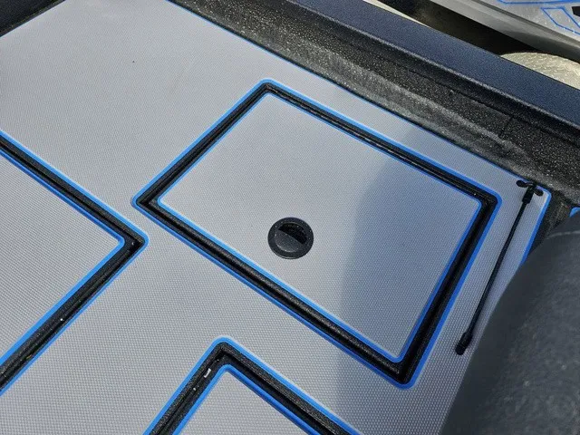 Slide: The Image of The image shows a boat floor with blue and black accents and a round handle. - 39