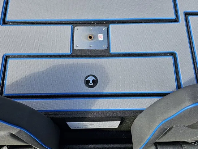 Slide: The Image of The image shows the deck of an Xpress H18C Crappie boat with blue accents and storage compartments. - 37