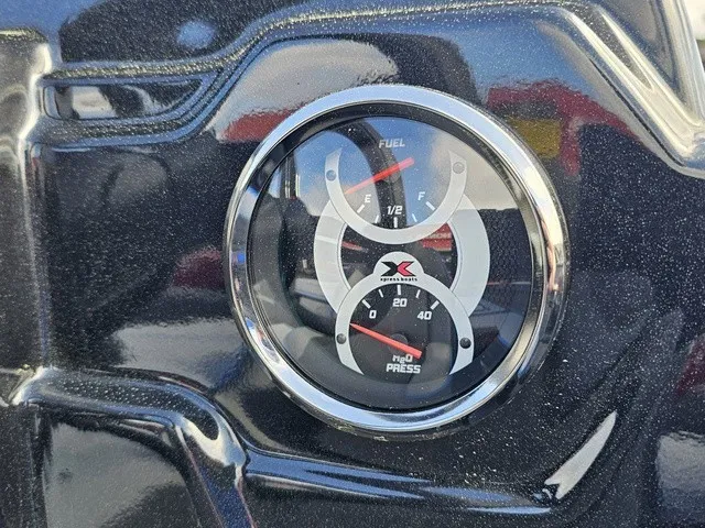 Slide: The Image of Close-up of a fuel and oil pressure gauge on an Xpress H18C Crappie boat. - 26