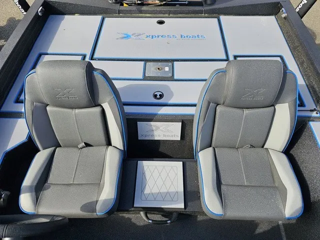 Slide: The Image of The image shows the interior of an Xpress H18C Crappie boat with two cushioned seats. - 34