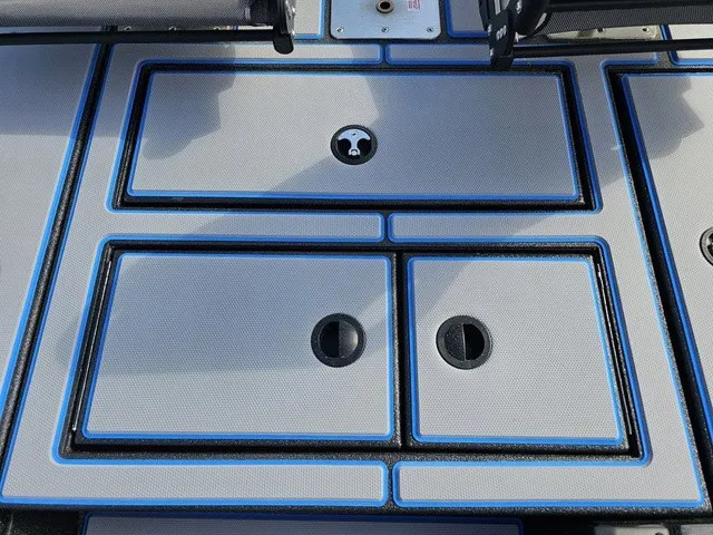 Slide: The Image of The image shows the deck of an Xpress H18C Crappie boat with blue accents. - 32