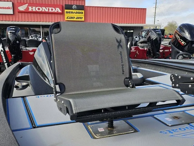 Slide: The Image of An Xpress H18C Crappie boat with a gray seat and engines in the background. - 19
