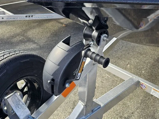 Slide: The Image of Close-up of a boat trailer with a black wheel and a winch. - 15