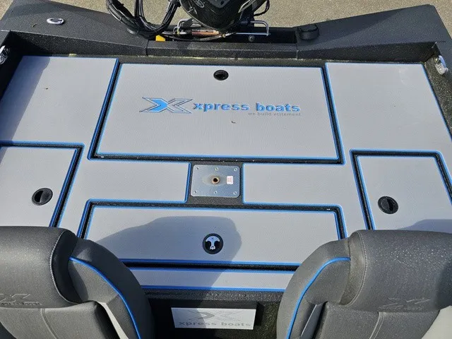Slide: The Image of The image shows the cockpit of an Xpress H18C Crappie boat with gray and blue accents. - 35