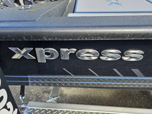 Slide: The Image of Close-up of the Xpress logo on a boat with textured metal flooring. - 12