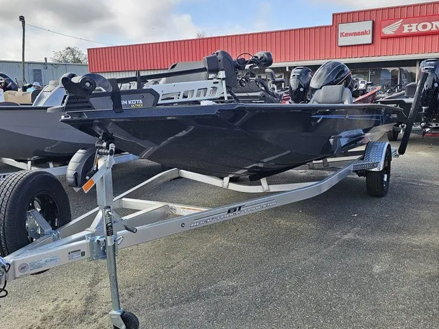 Slide: The Image of A 2026 Xpress H18C Crappie boat on a trailer in front of a store. - 2