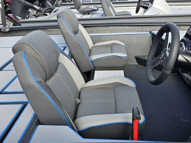 Slide: The Image of Interior of an Xpress H18C Crappie boat with gray and blue seats and a steering wheel. - 21