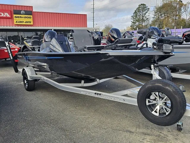 Slide: The Image of A black 2026 Xpress H18C Crappie boat on a trailer in front of a store. - 4