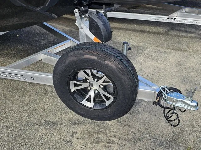 Slide: The Image of Close-up of a boat trailer with a black wheel and silver rim. - 13