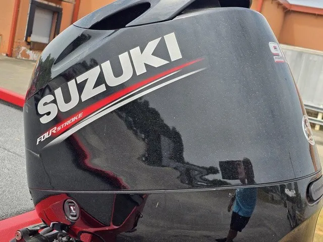 Slide: The Image of Close-up of a Suzuki four-stroke outboard motor on a boat. - 28