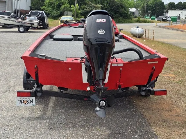 Slide: The Image of A red 2021 Caravelle Raptor 200 boat with a 90 HP outboard motor. - 8