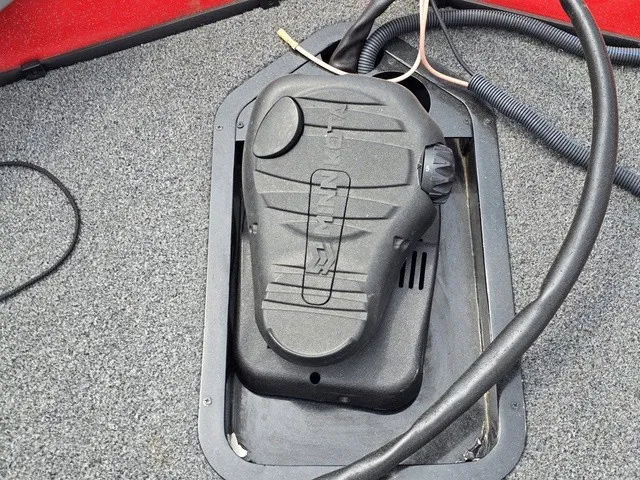 Slide: The Image of A black plastic housing is embedded in the gray floor of a boat, surrounded by cables. - 25