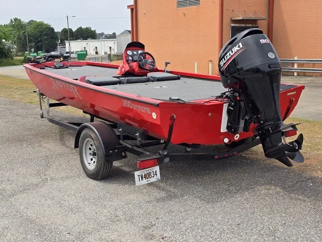 Slide: The Image of A red 2021 Caravelle Raptor 200 boat on a trailer. It features a Suzuki outboard motor. - 9