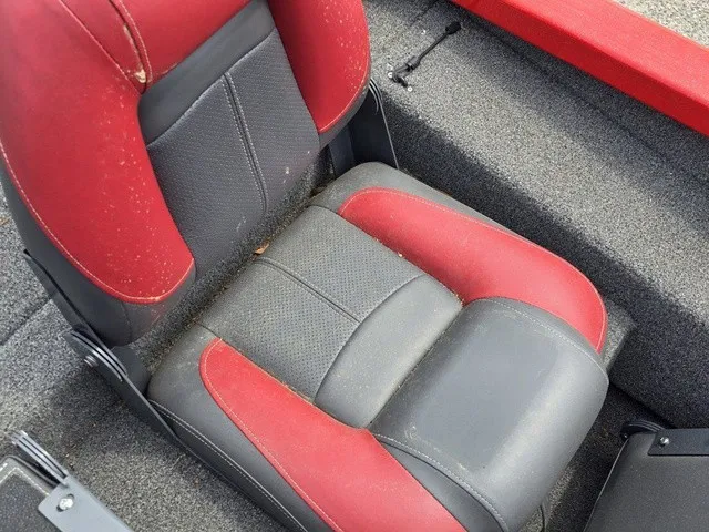 Slide: The Image of A seat with black and red upholstery in a boat. - 27