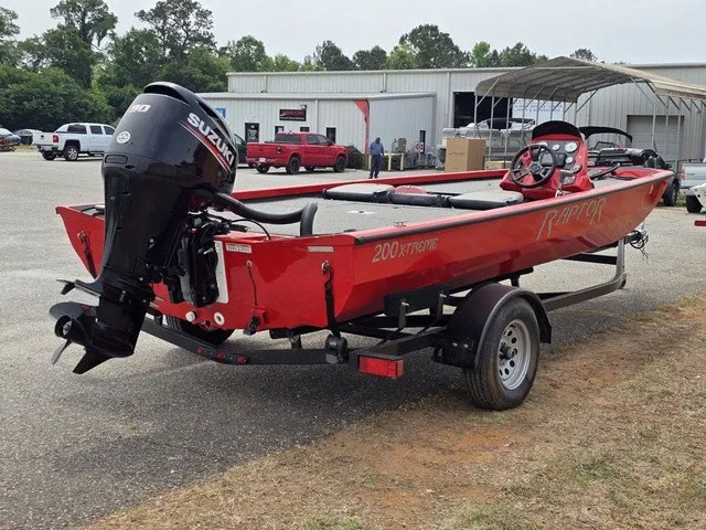 Slide: The Image of A red 2021 Caravelle Raptor 200 boat on a trailer in an outdoor setting. - 7
