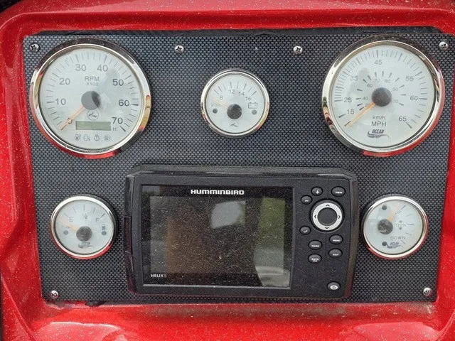 Slide: The Image of Dashboard of a 2021 Caravelle Raptor 200 with gauges and a Humminbird device. - 18