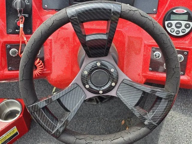 Slide: The Image of The image shows a steering wheel of a 2021 Caravelle Raptor 200 boat. - 16