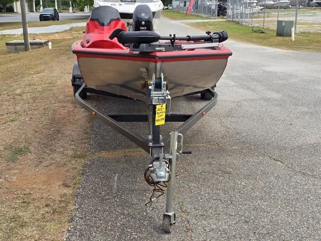 Slide: The Image of A 2021 Caravelle Raptor 200 boat on a trailer in a parking area. - 3