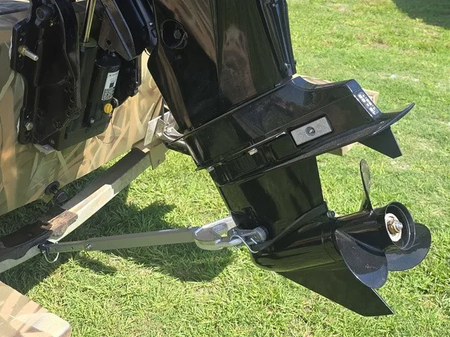 Slide: The Image of An outboard motor with a propeller is attached to a boat resting on grass. - 27