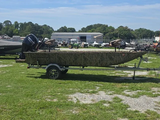 Slide: The Image of A 2025 Lowe RX1760 boat on a trailer, parked on grass. - 5