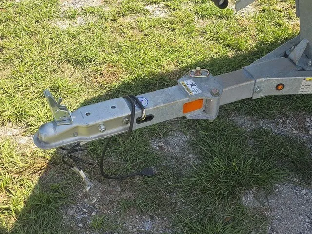 Slide: The Image of Close-up of a boat trailer hitch on grass. - 13