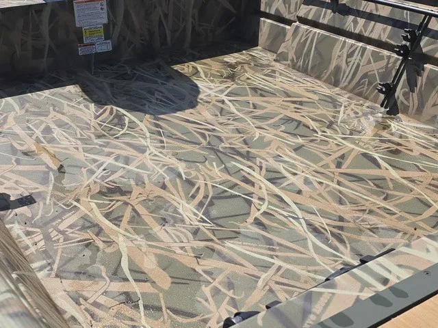 Slide: The Image of The image shows the interior of a Lowe RX1760 boat with a camouflage pattern. - 20