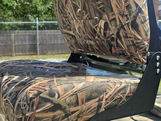 Slide: The Image of Close-up of a camo-patterned boat seat mounted on a metal frame. - 29