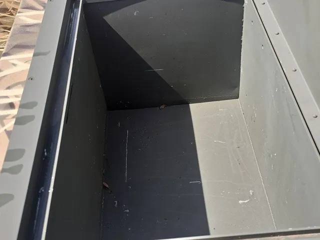 Slide: The Image of An empty, rectangular storage compartment in a boat, with a shadow on the right side. - 19