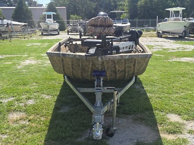 Slide: The Image of A 2025 Lowe RX1760 boat on a trailer, parked on grass. - 3