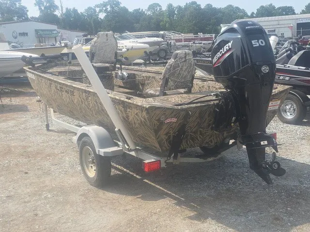 Slide: The Image of A 2022 Lowe Skorpion SS boat with a Mercury 50 outboard motor, parked on a trailer. - 8