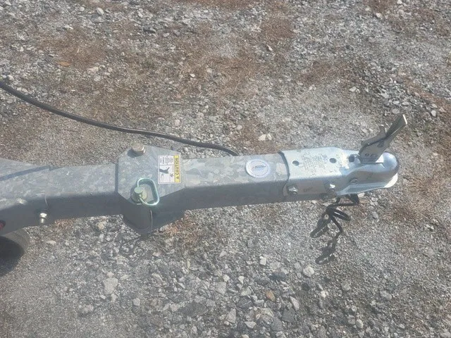 Slide: The Image of Close-up of a boat trailer on gravel, featuring a hitch and cable. - 28