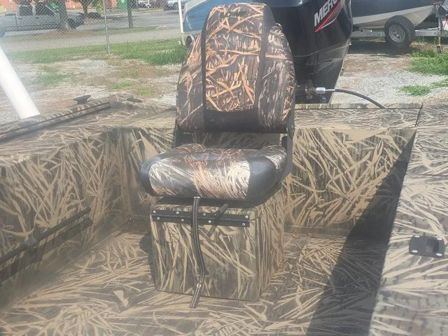 Slide: The Image of A 2022 Lowe Skorpion SS with a camouflaged seat and flooring, ideal for fishing trips. - 17